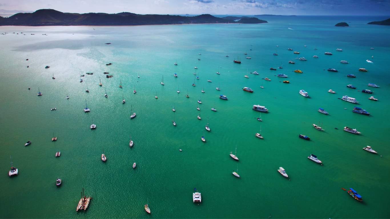 Popular bay in phuket adorned with boats of all kinds