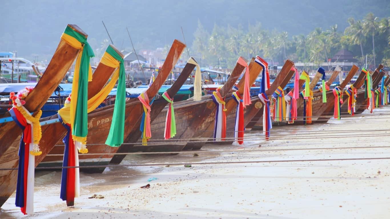 Traditional longtail boats along phi phi don shoreline