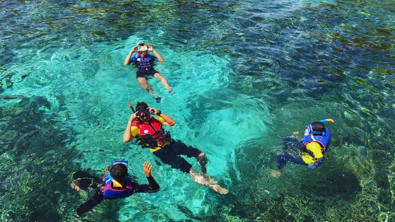 Team snorkeling in the crystal clear andaman sea