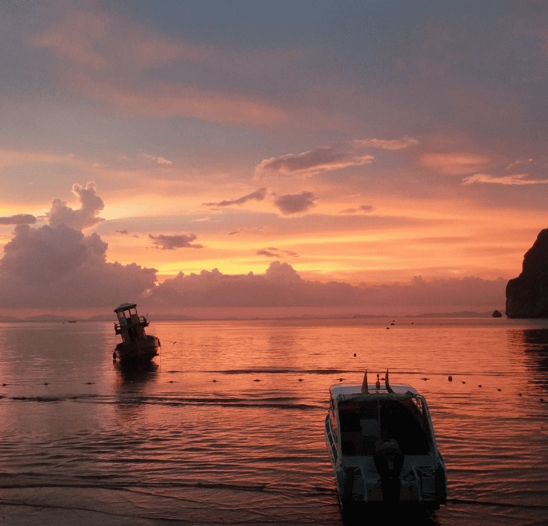 Phi phi private boat tour parked on the beach during sunset